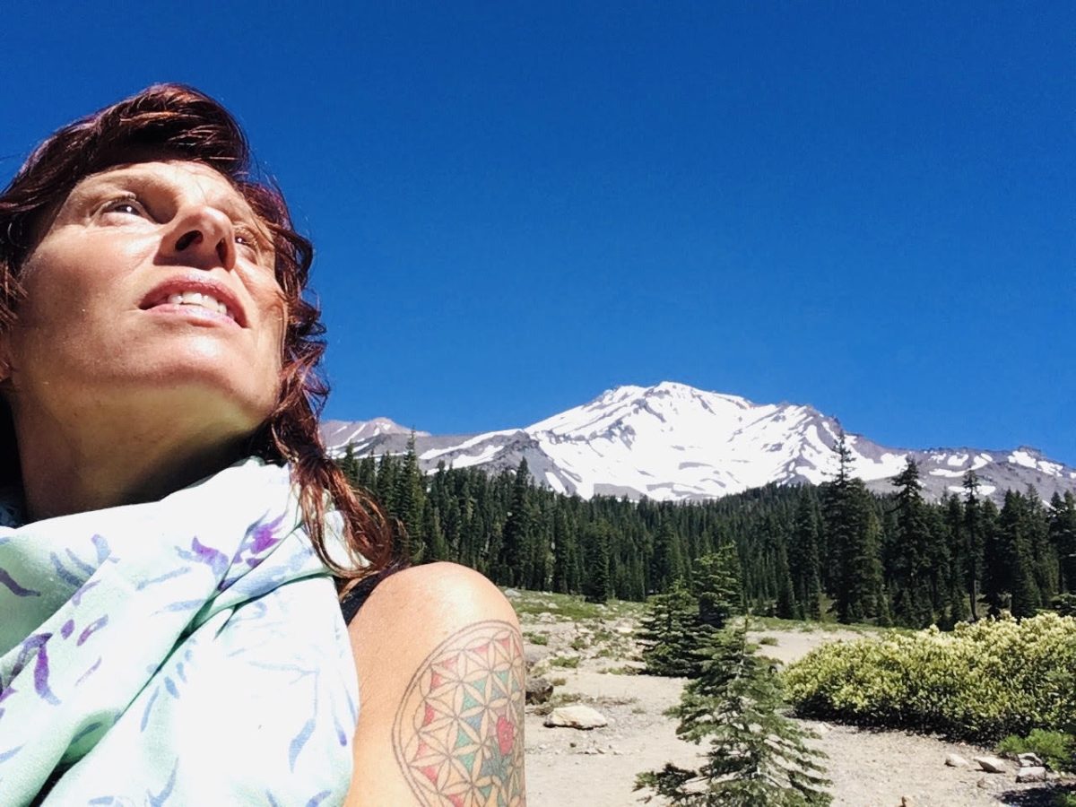 Reiki Master Shekhina Von Recklinghausen standing near Mount Shasta, radiating energy healing and spiritual growth—offering Reiki healing, chakra balancing, and self-empowerment for women in San Francisco.