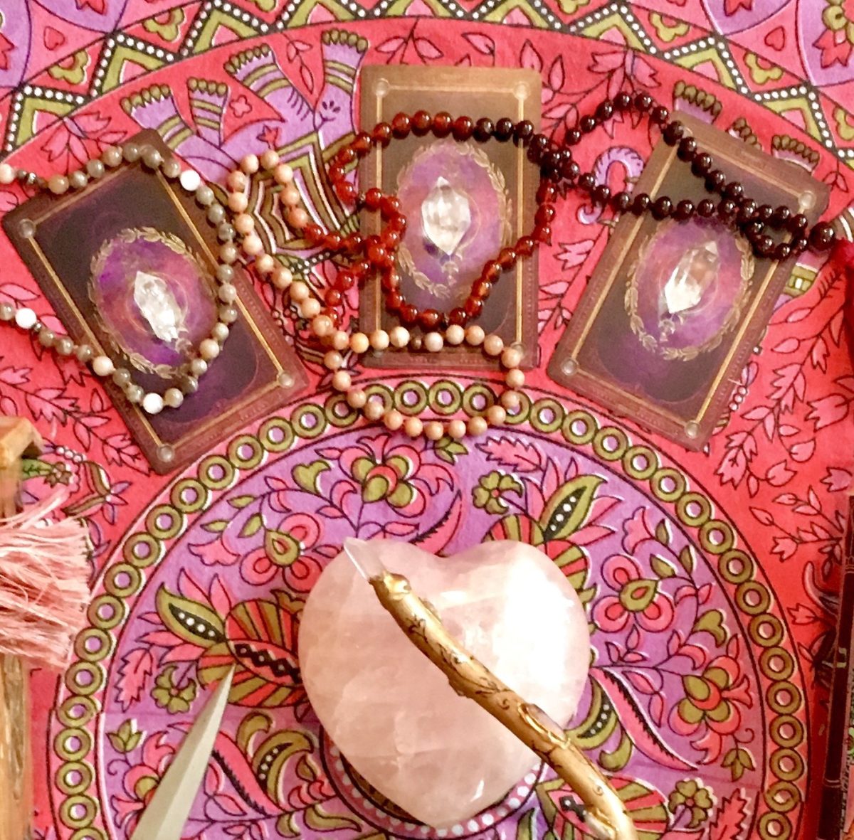 Tarot cards laid out on a vibrant spiritual altar with rose quartz and crystals, representing intuitive tarot readings for clarity, healing, and self-growth.
